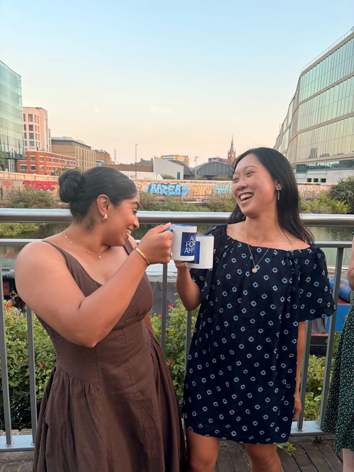 Branded AI for AHPs mugs held by community members