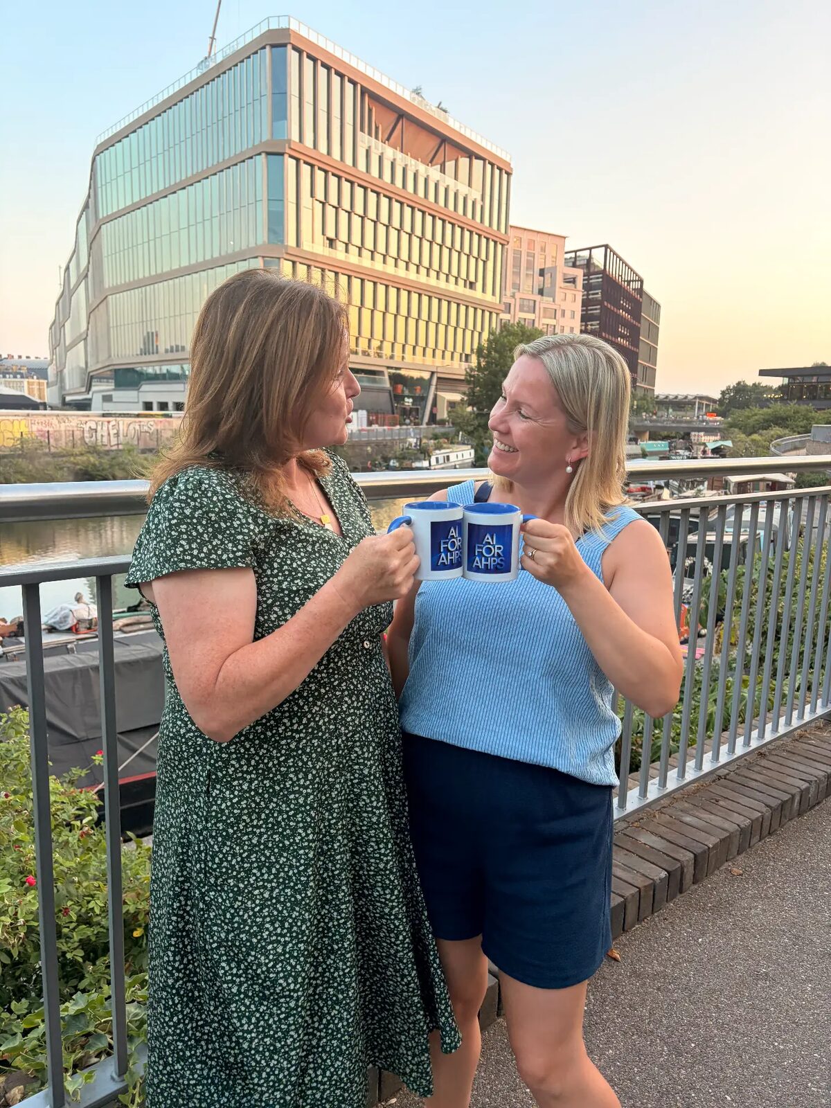 Two members of the AI for AHPs team at a community event